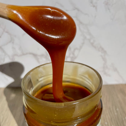 Thick Salted Caramel Sauce pouring into a jar, Montana's Table