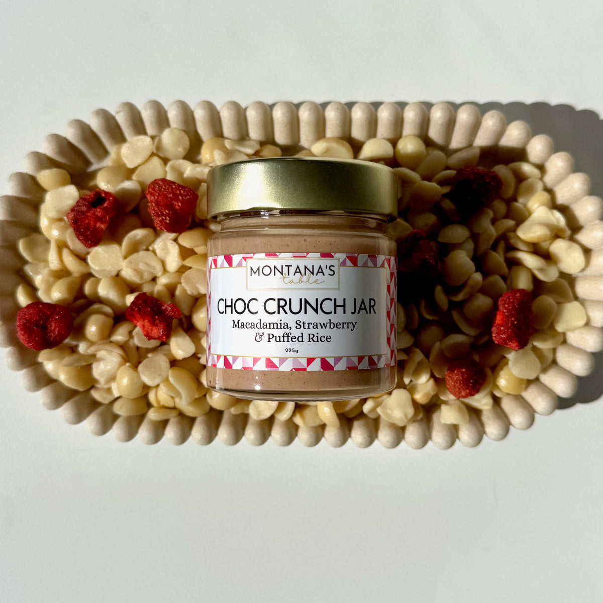 Montana's Table Strawberry Macadamia Crunch Jar styled on a decorative tray